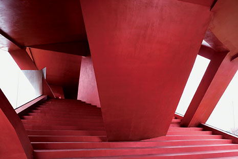 The building’s brightly-coloured concrete shell conceals a structural steel frame

