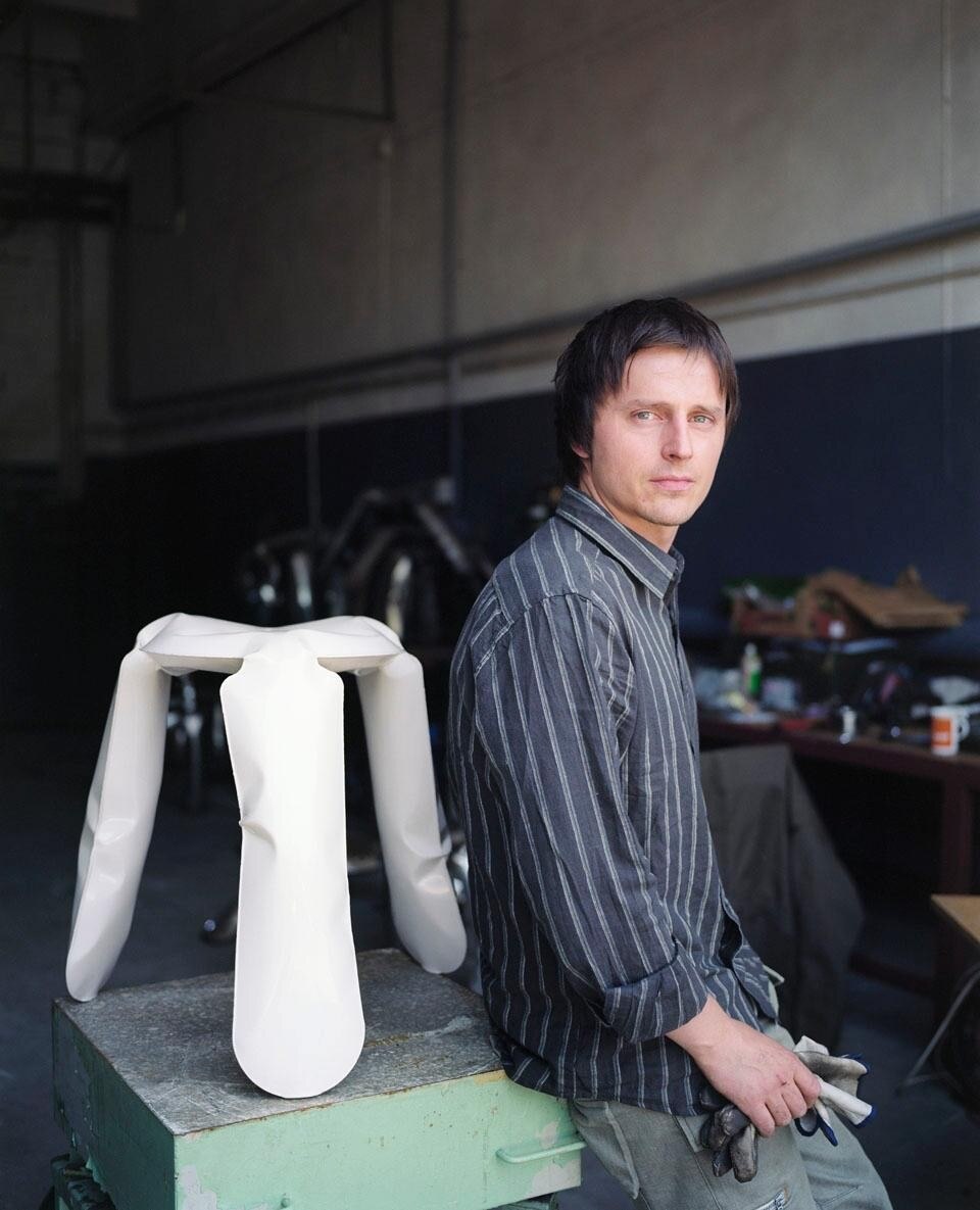 Oskar Zieta in his studio. Behind him, the Plopp stool