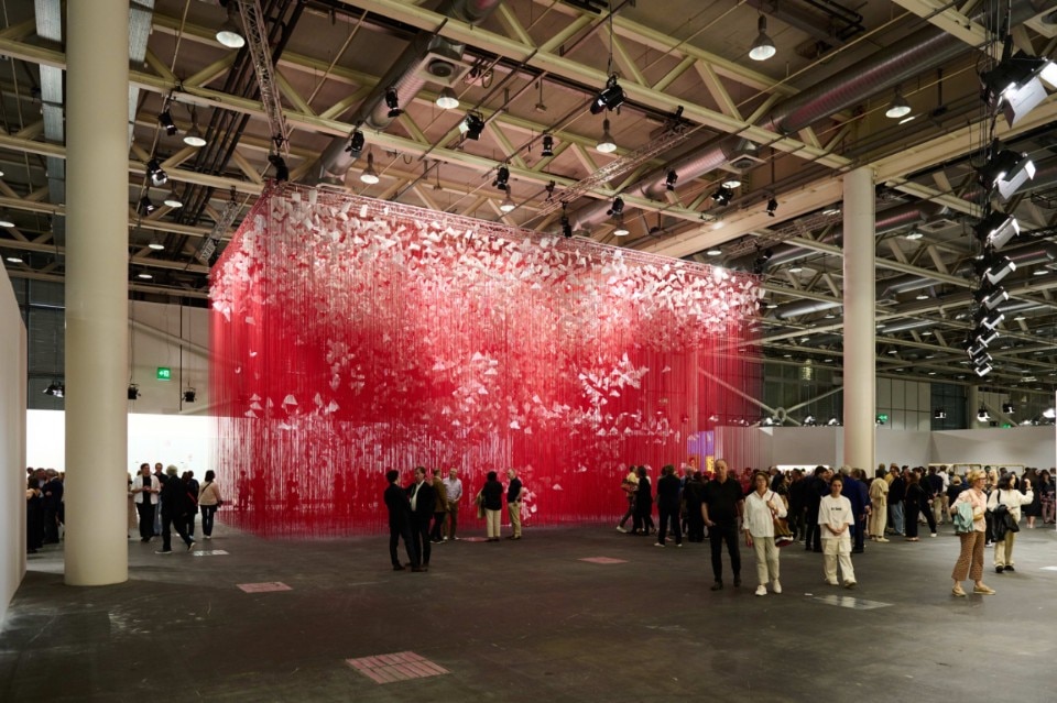 Visitors in front of Chiharu Shiota's work, presented by Templon at Art Basel 2024.