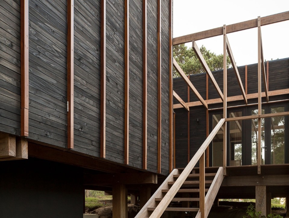 A stilt house in Uruguay made of different types of wood