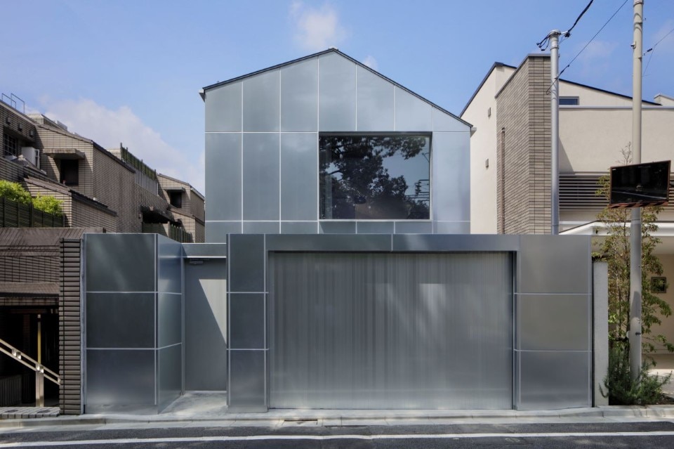 Galvanized steel slabs clad a wooden house in Japan