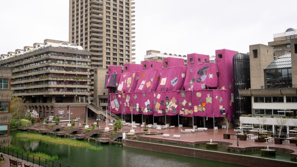 Photos of the Barbican Center wrapped with traditional Ghanaian fuchsia fabrics