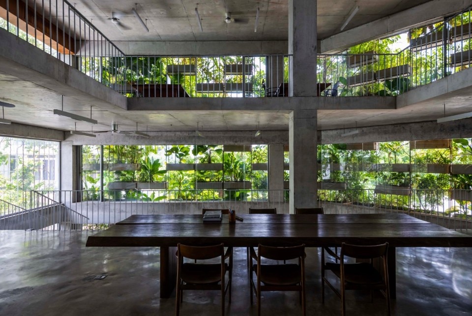 A concrete office building covered with vertical farms