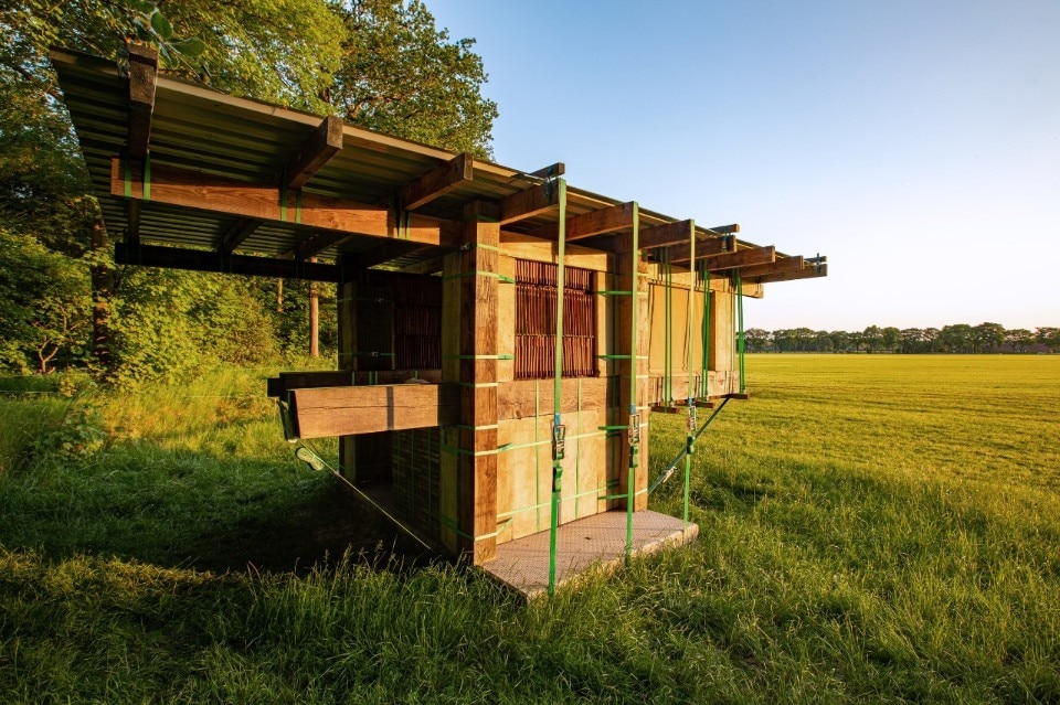 A hotel cabin made from borrowed materials and tie-down straps